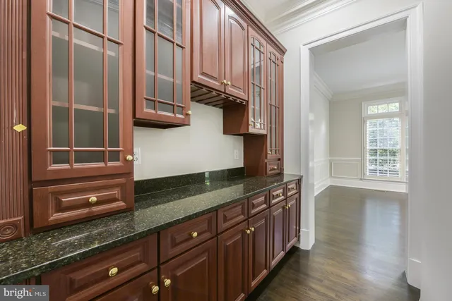 a kitchen with stainless steel appliances granite countertop a sink and a refrigerator