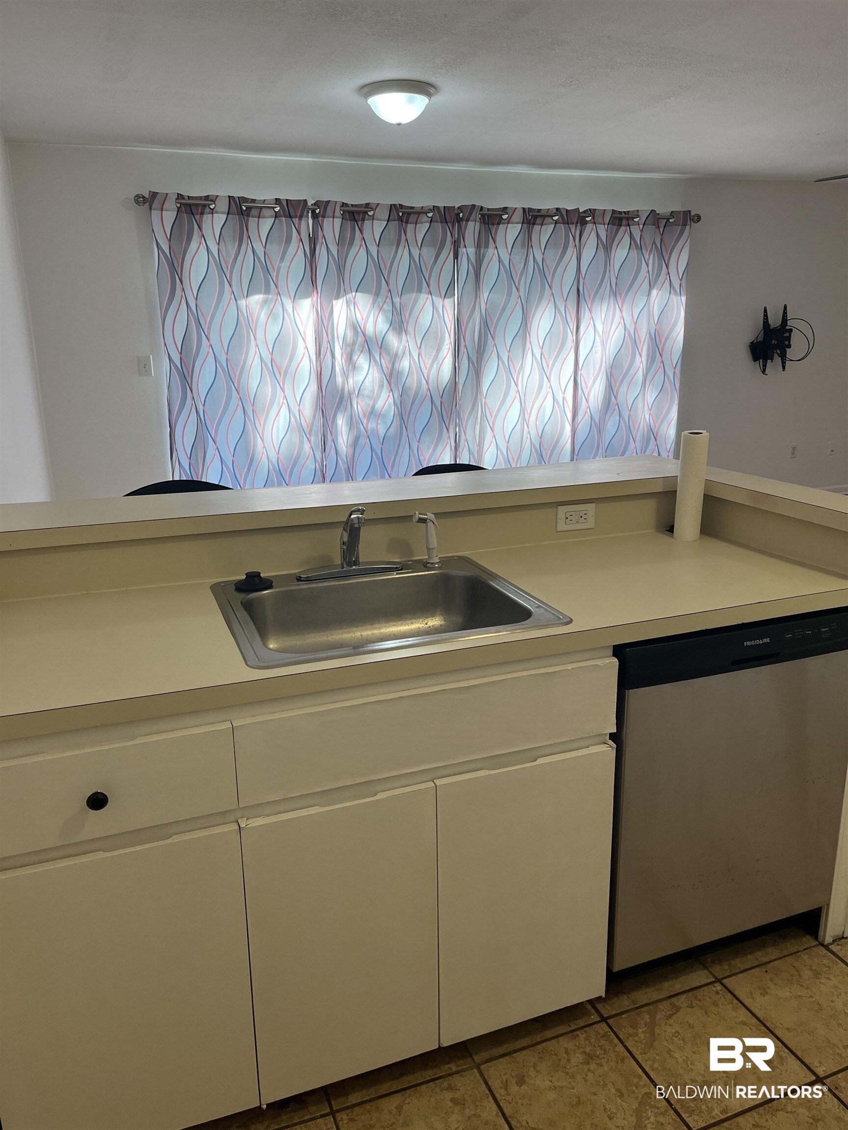 1146 North Alston Street Foley, AL 36535 - Photo 8 of 20 Kitchen featuring light countertops, dishwasher, and white cabinetry
