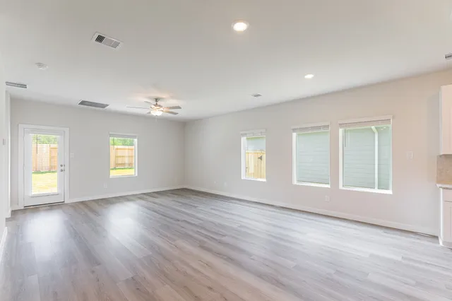 a view of kitchen with wooden floor and electronic appliances