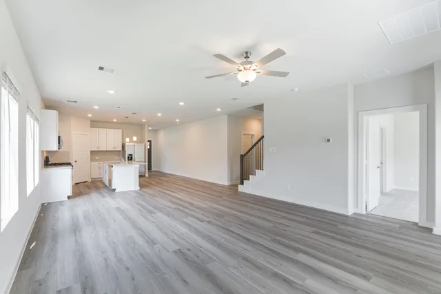 a view of an empty room with a kitchen