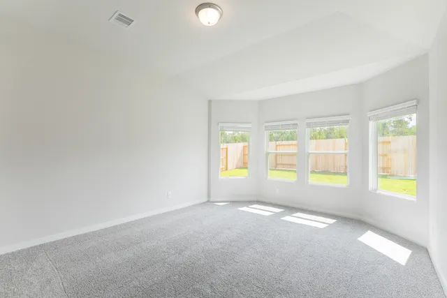 a view of an empty room and wooden floor