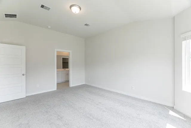 an empty room with wooden floor and window