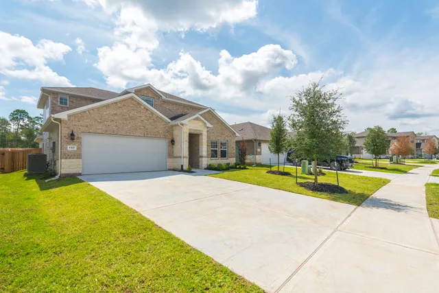 a view of pool with umbrella and wooden fence
