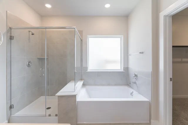 a bathroom with a double vanity sink tub double and mirror