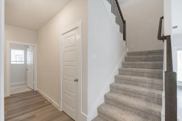 a bathroom with a bathtub a window and a shower