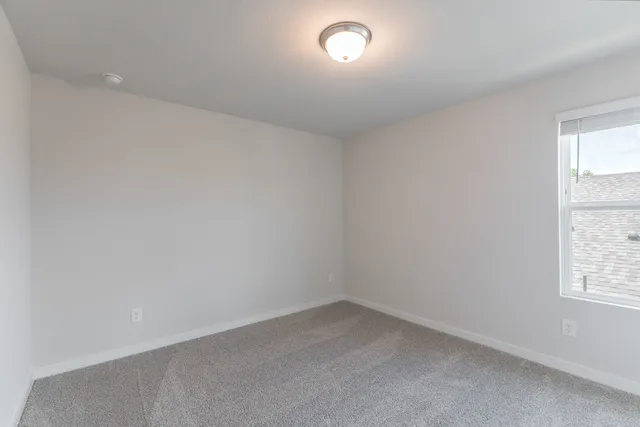 an empty room with kitchen and sink