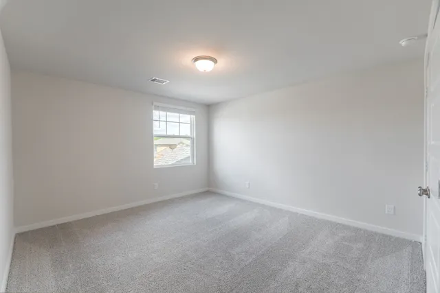 an empty room with closet area