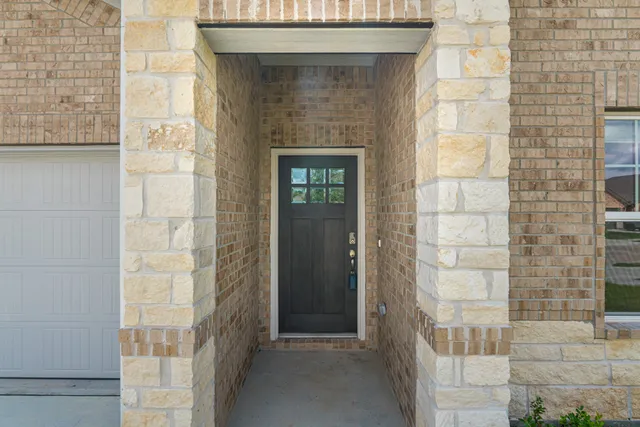 a front view of house with a garden