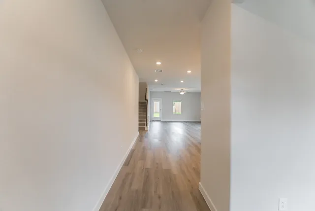 a view of hallway with wooden floor