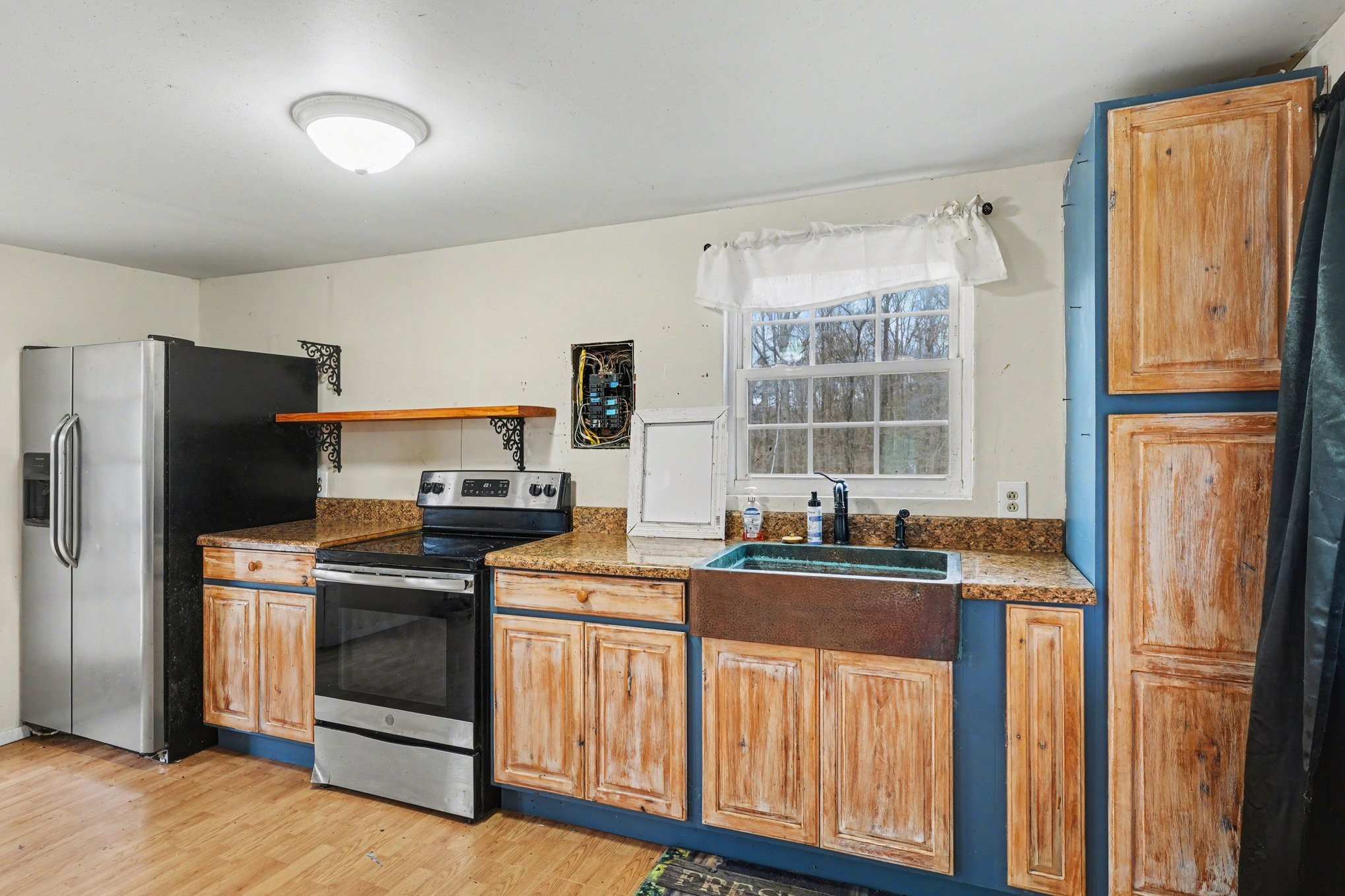 1323 Old Stage Road Charlotte, TN 37036 - Photo 7 of 25 a kitchen with stainless steel appliances white cabinets and a refrigerator