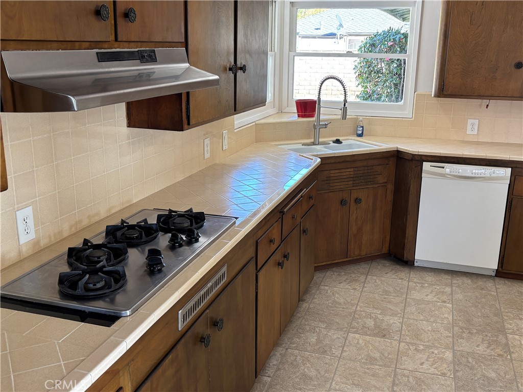 15828 West Road Whittier, CA 90603 - Photo 11 of 20 a kitchen with a sink stove and cabinets