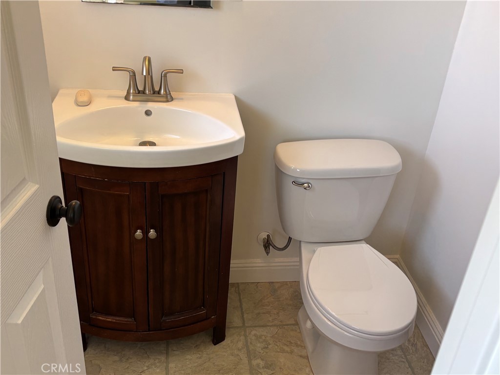 15828 West Road Whittier, CA 90603 - Photo 18 of 20 a white toilet sitting next to a bathroom sink