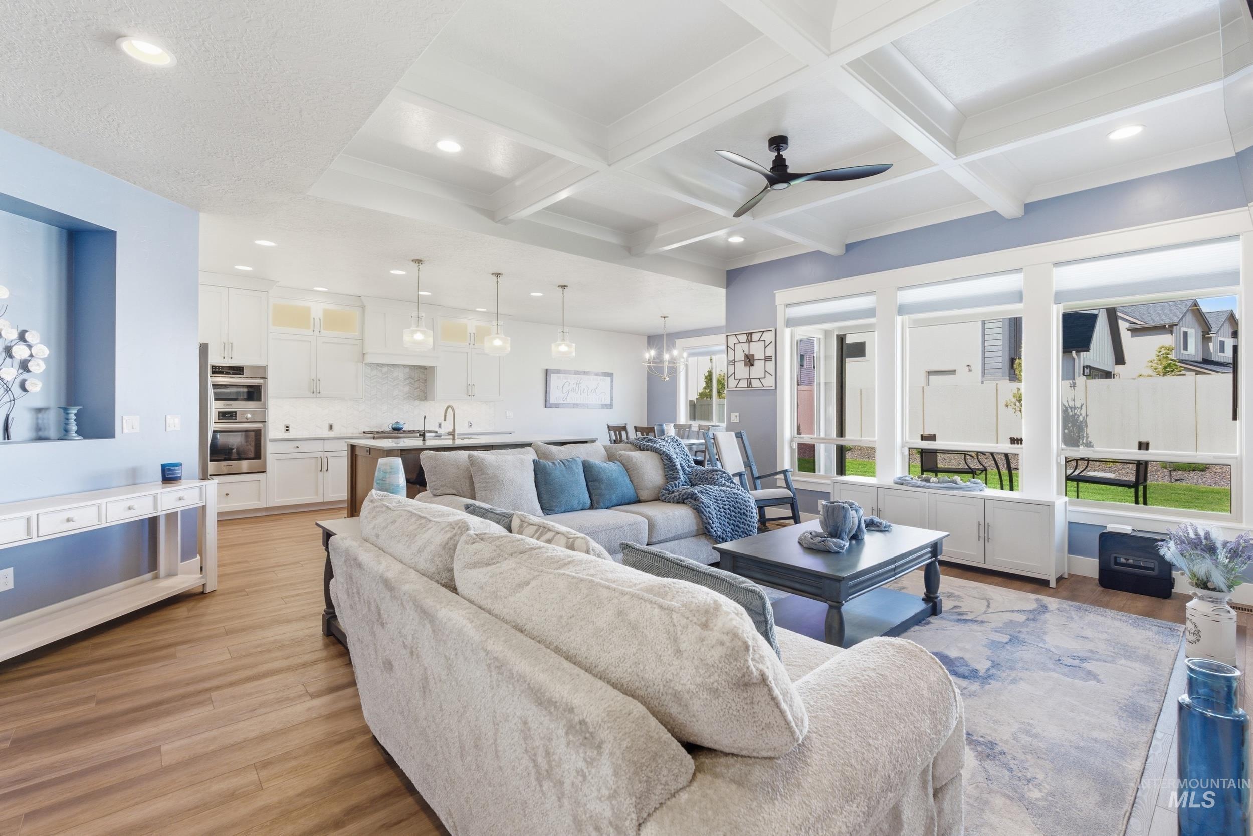 6347 South Utmost Lane Meridian, ID 83642 - Photo 7 of 37 Open-concept living area featuring wood-finish flooring and a coffered ceiling with recessed lighting