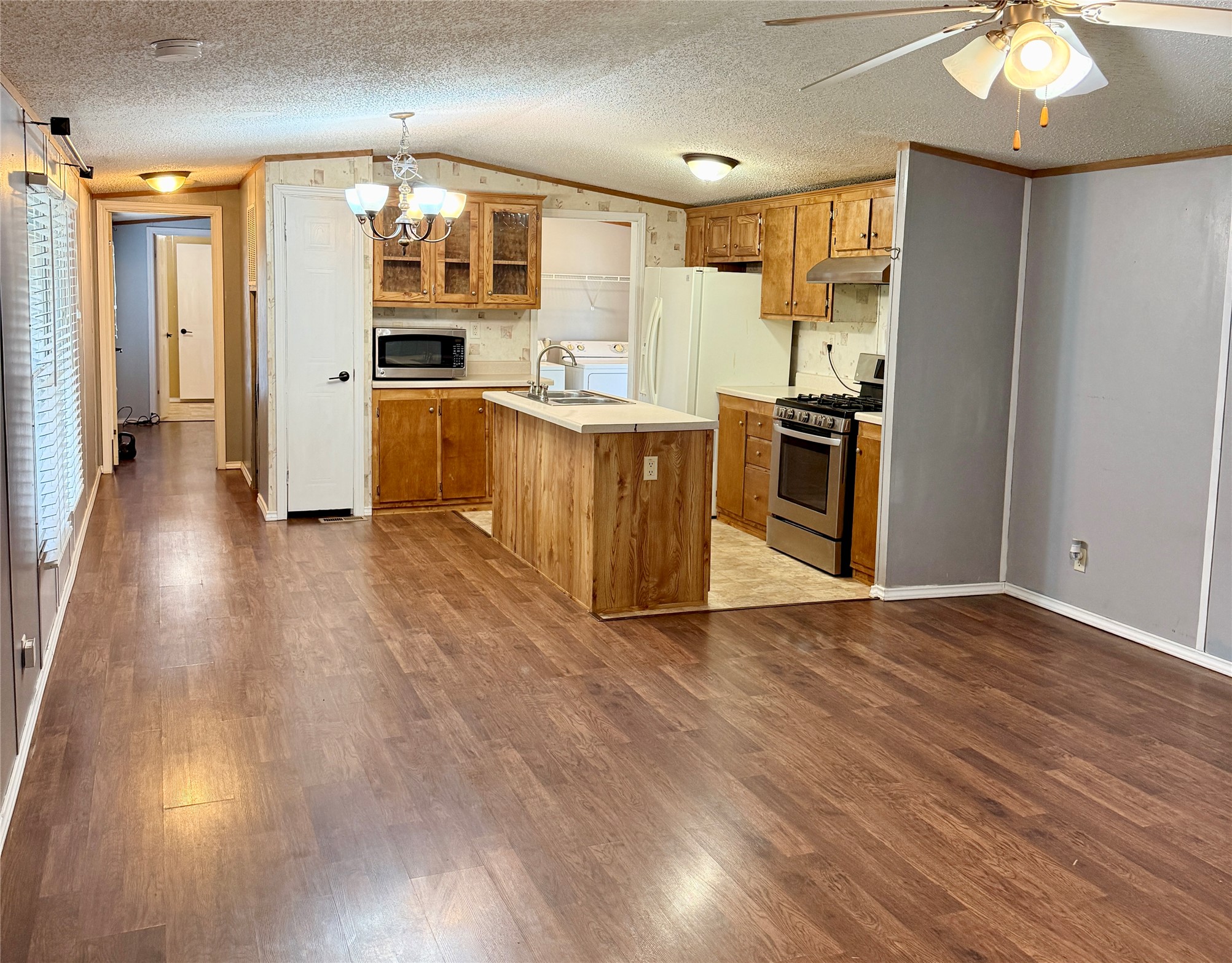 3075 FM 2001 Buda, TX 78610 - Photo 9 of 26 The kitchen features an island & rich wood cabinetry.