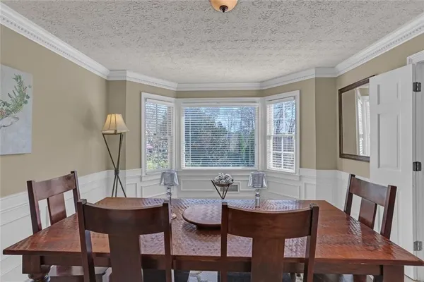 a view of a dining room with furniture and window