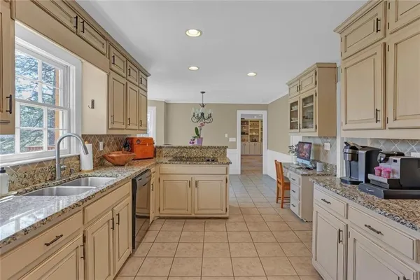 a kitchen with stainless steel appliances granite countertop a sink and cabinets