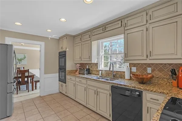 a kitchen with stainless steel appliances granite countertop a sink and cabinets