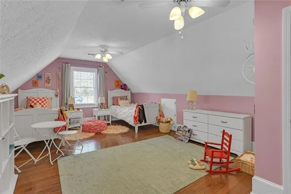 a living room with furniture a air conditioner vent and a window