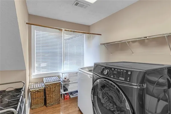 a view of living room filled with furniture and windows