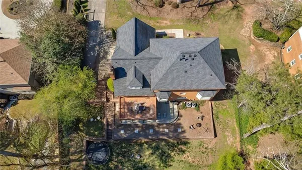 an aerial view of a house with swimming pool and sitting area