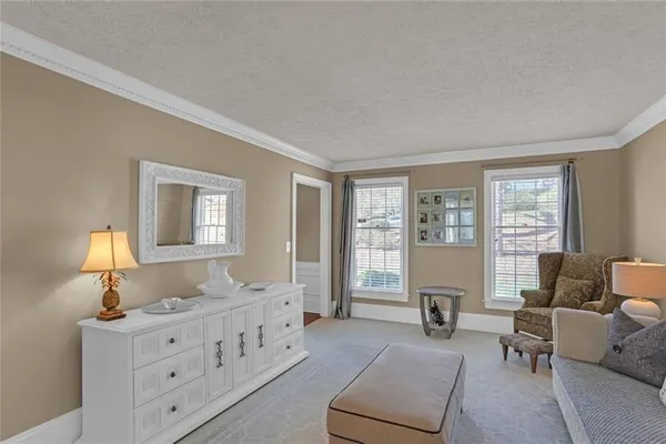 a spacious bedroom with furniture and windows