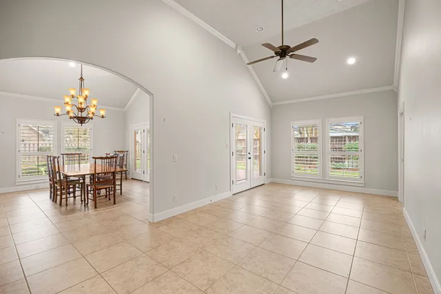 a large white kitchen with cabinets