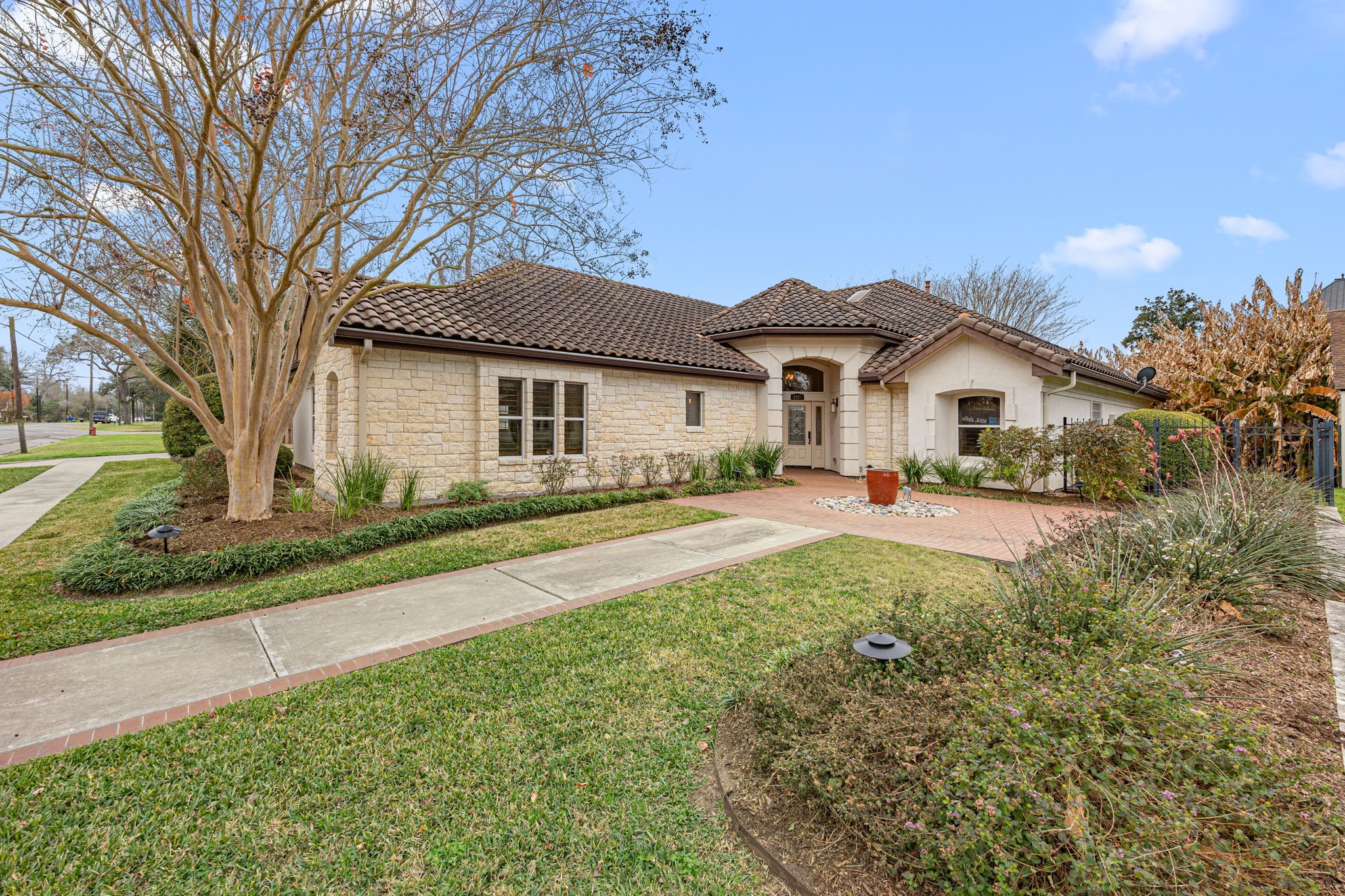 1220 Travis Street Columbus, TX 78934 - Photo 2 of 39 a view of house with a yard and potted plants