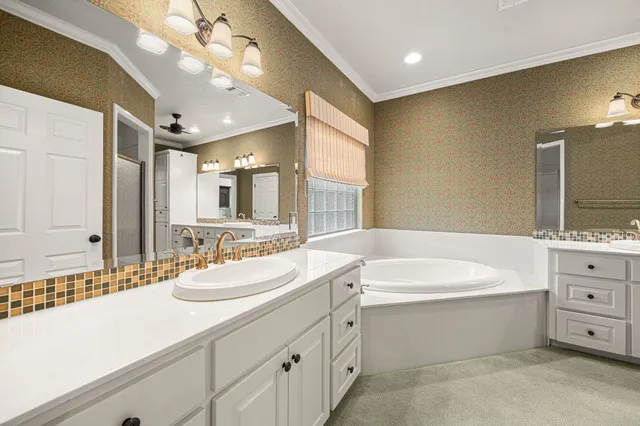 a bathroom with a bathtub sink and mirror