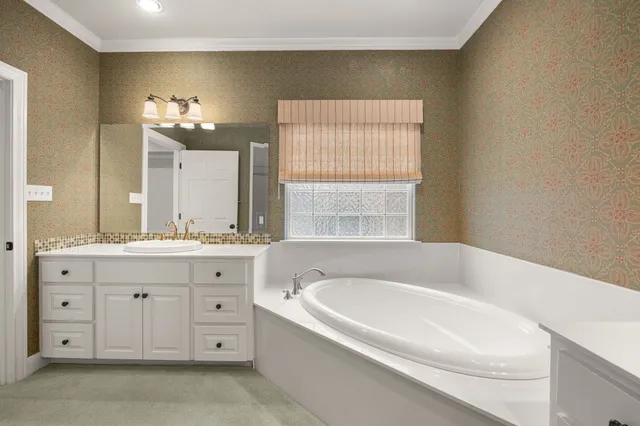 a spacious bathroom with a double vanity sink a large mirror and a shower