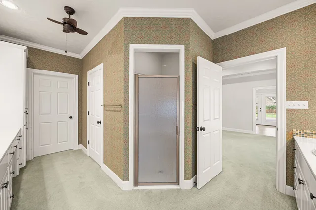 a white bath tub sitting in a bathroom next to a window