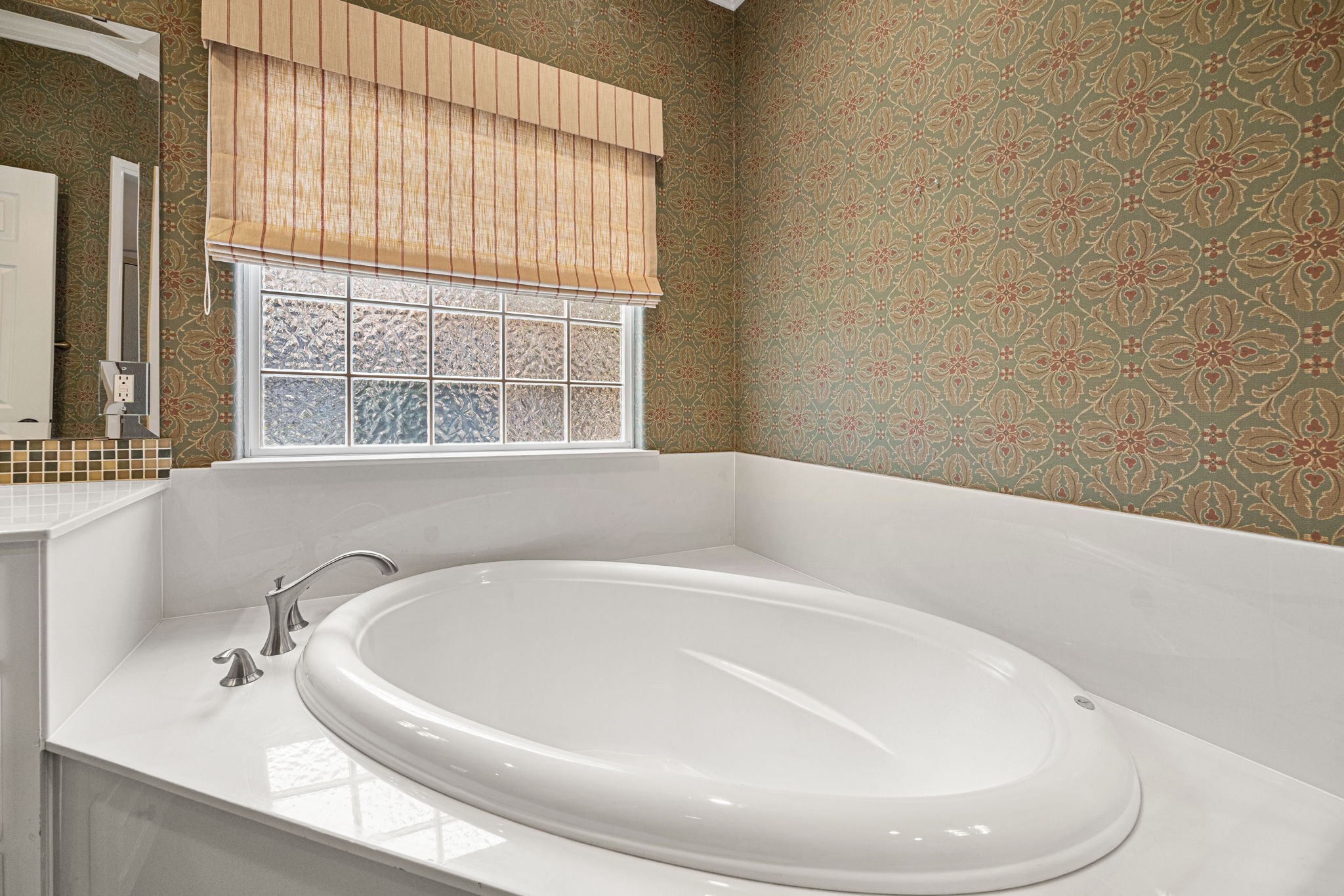 1220 Travis Street Columbus, TX 78934 - Photo 25 of 39 a white bath tub sitting in a bathroom next to a window