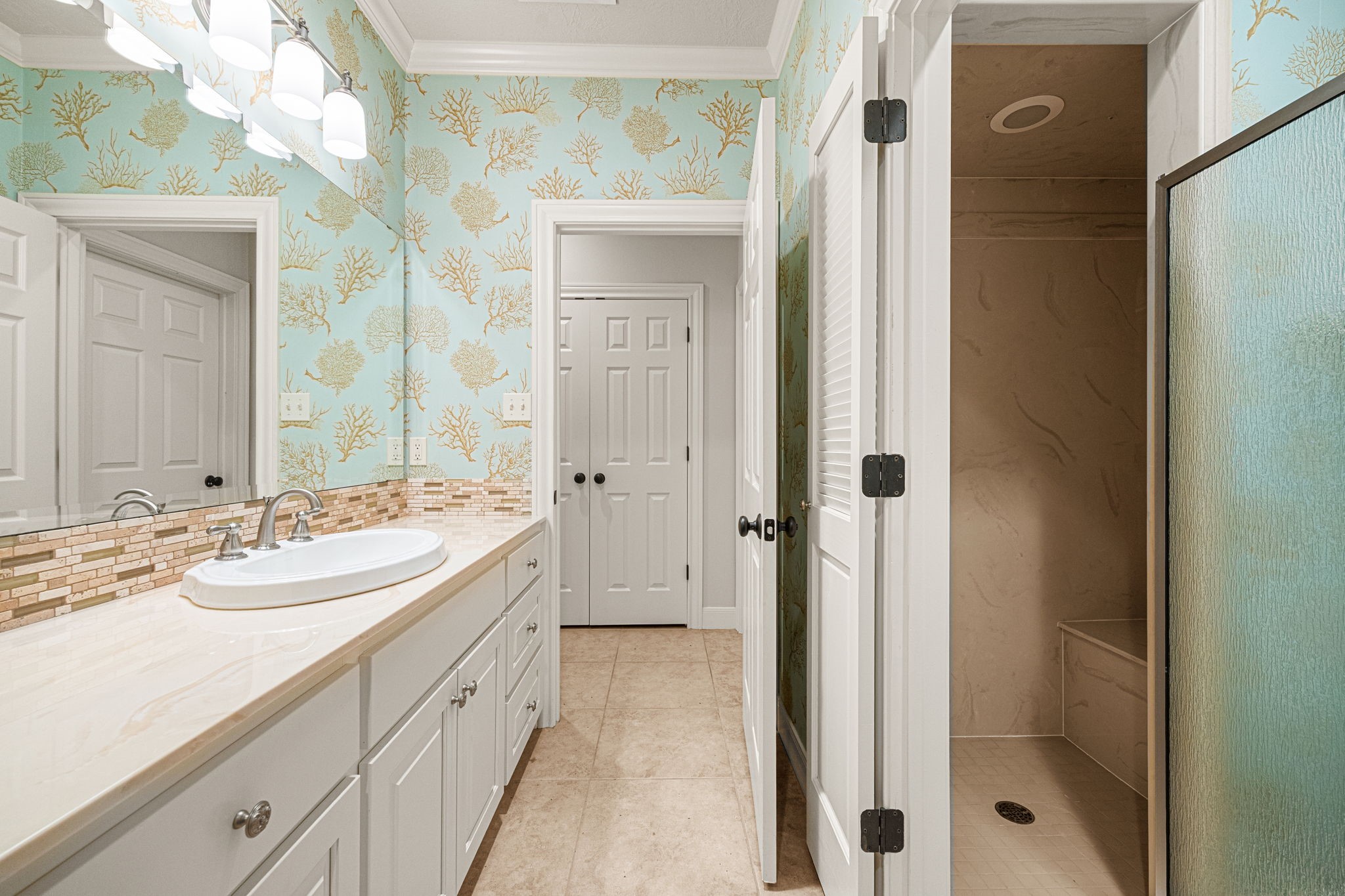 1220 Travis Street Columbus, TX 78934 - Photo 31 of 39 a spacious bathroom with a shower sink and mirror