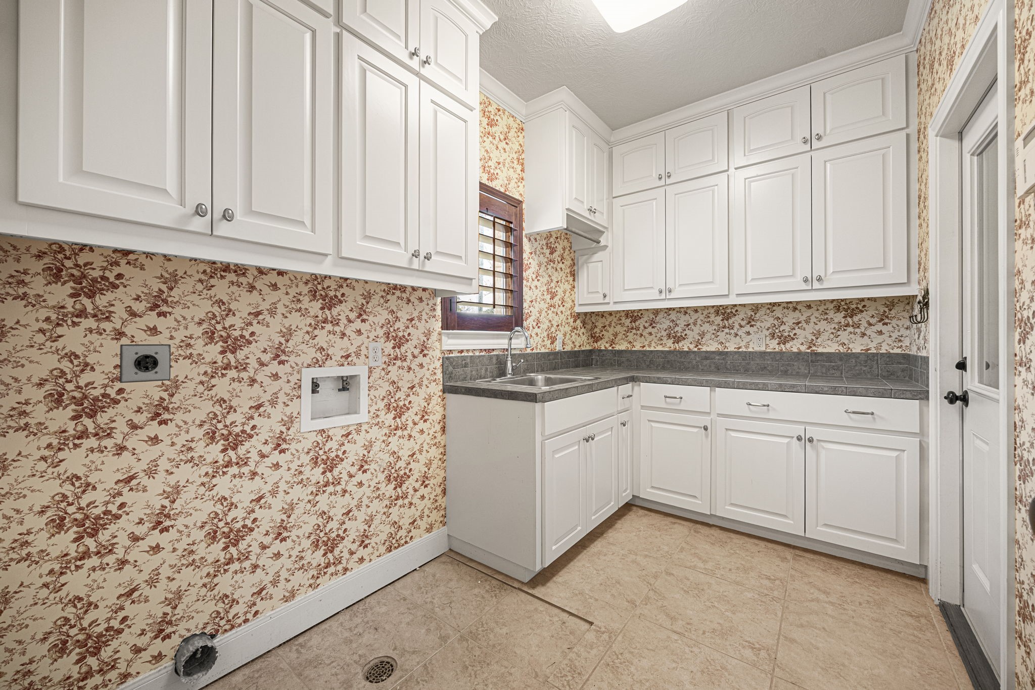 1220 Travis Street Columbus, TX 78934 - Photo 32 of 39 a kitchen with granite countertop white cabinets and sink