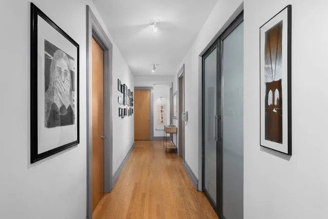 a view of hallway with wooden floor