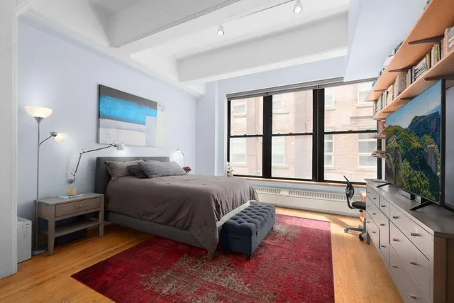 a kitchen with stainless steel appliances kitchen island granite countertop a table chairs in it and wooden floors