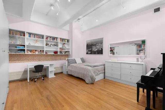 a bedroom with a workspace