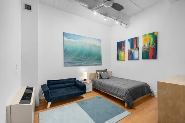 a bedroom with a bed and a couch