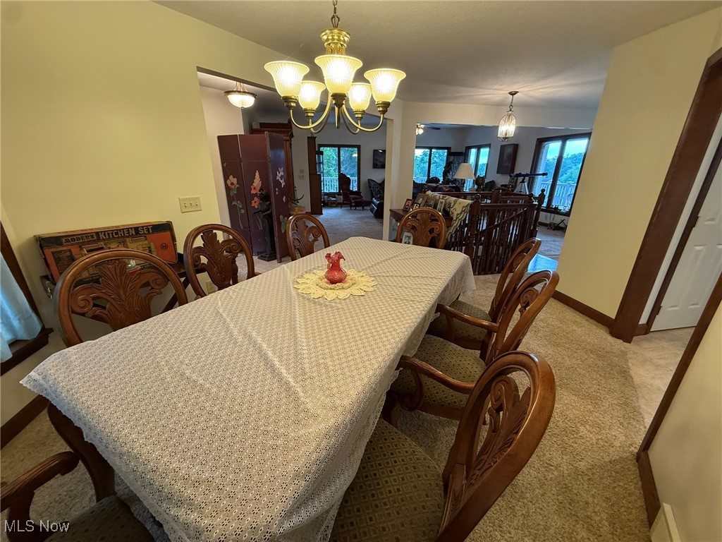 2597 Pyle Road Dover, OH 44622 - Photo 20 of 50 Dining space with light carpet and a chandelier