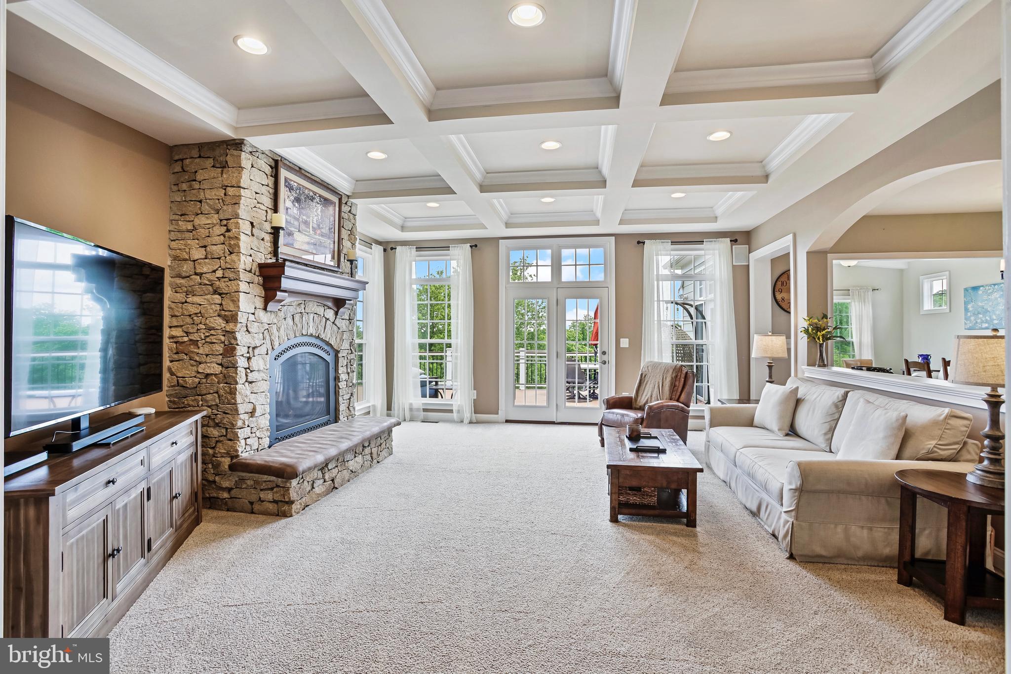 18604 Wild Raspberry Drive Purcellville, VA 20132 - Photo 17 of 58 a living room with furniture a flat screen tv and a fireplace