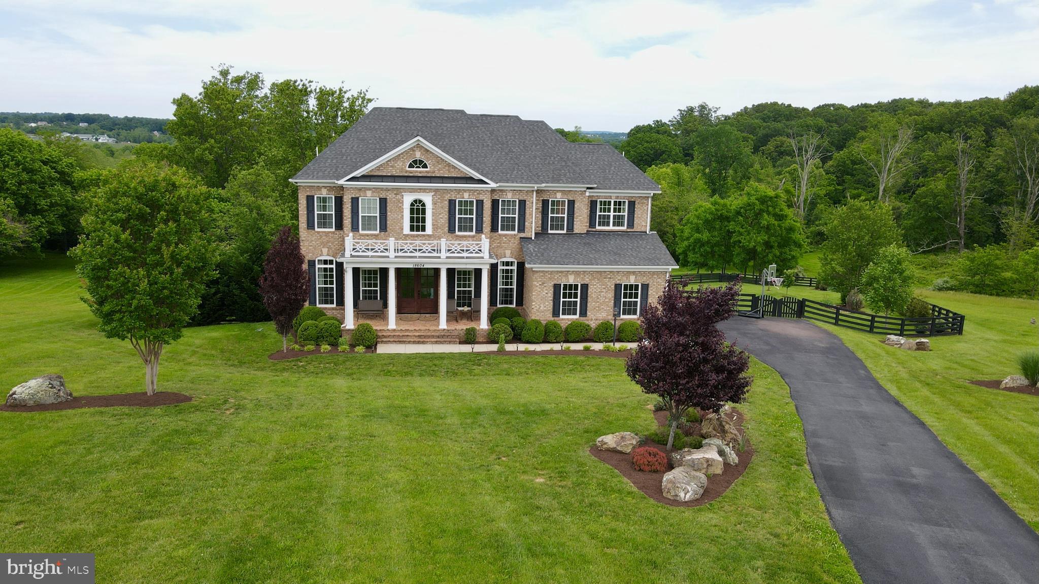 18604 Wild Raspberry Drive Purcellville, VA 20132 - Photo 2 of 58 a front view of a house with a yard table and chairs