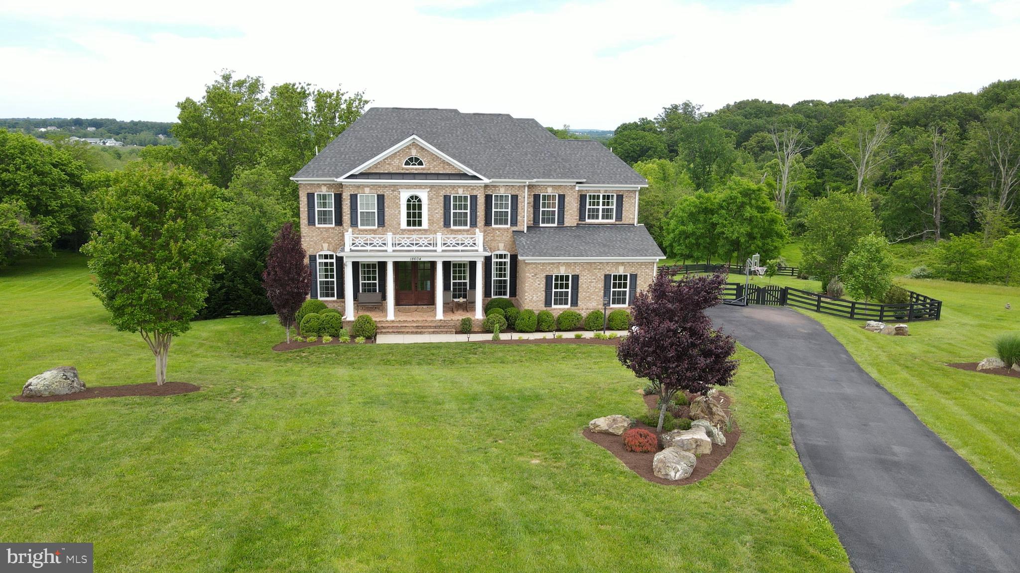 18604 Wild Raspberry Drive Purcellville, VA 20132 - Photo 3 of 58 a front view of a house with a yard table and chairs