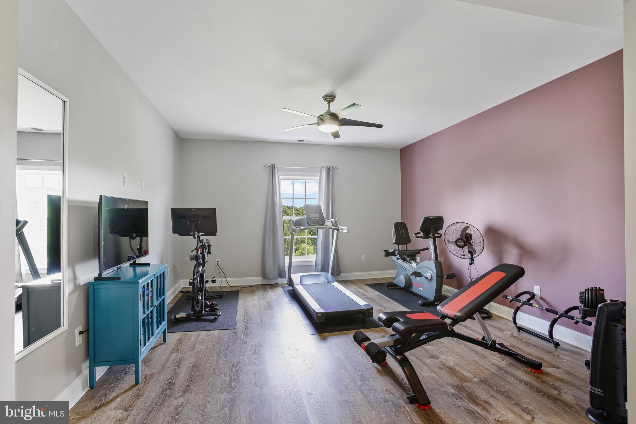 18604 Wild Raspberry Drive Purcellville, VA 20132 - Photo 37 of 58 a living room with furniture a flat screen tv and a window