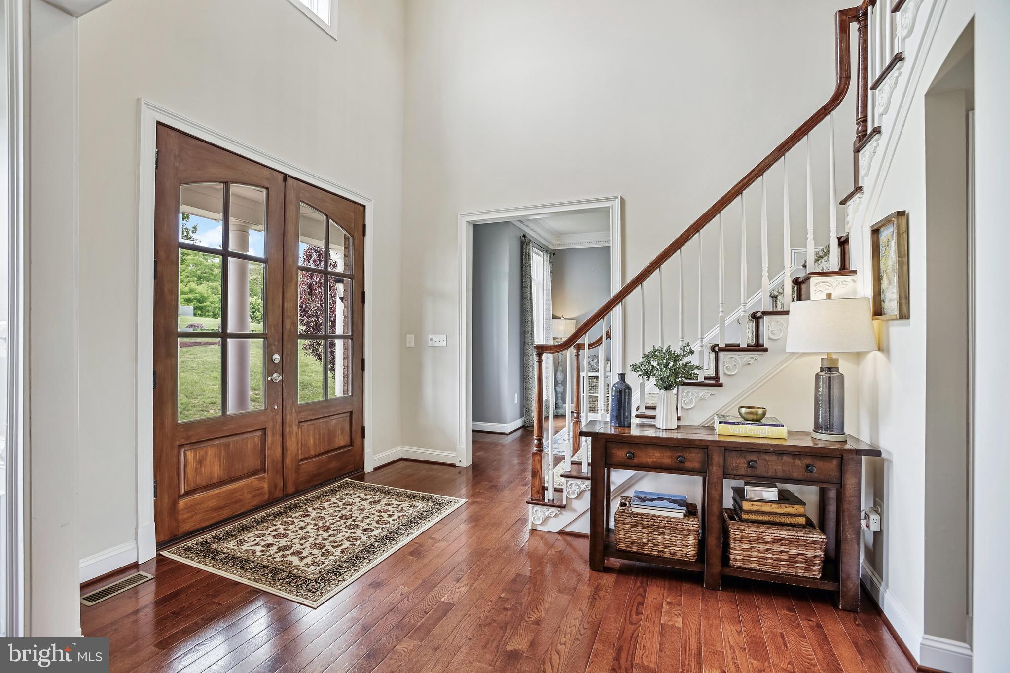 18604 Wild Raspberry Drive Purcellville, VA 20132 - Photo 4 of 58 a view of an entryway with wooden floor and door