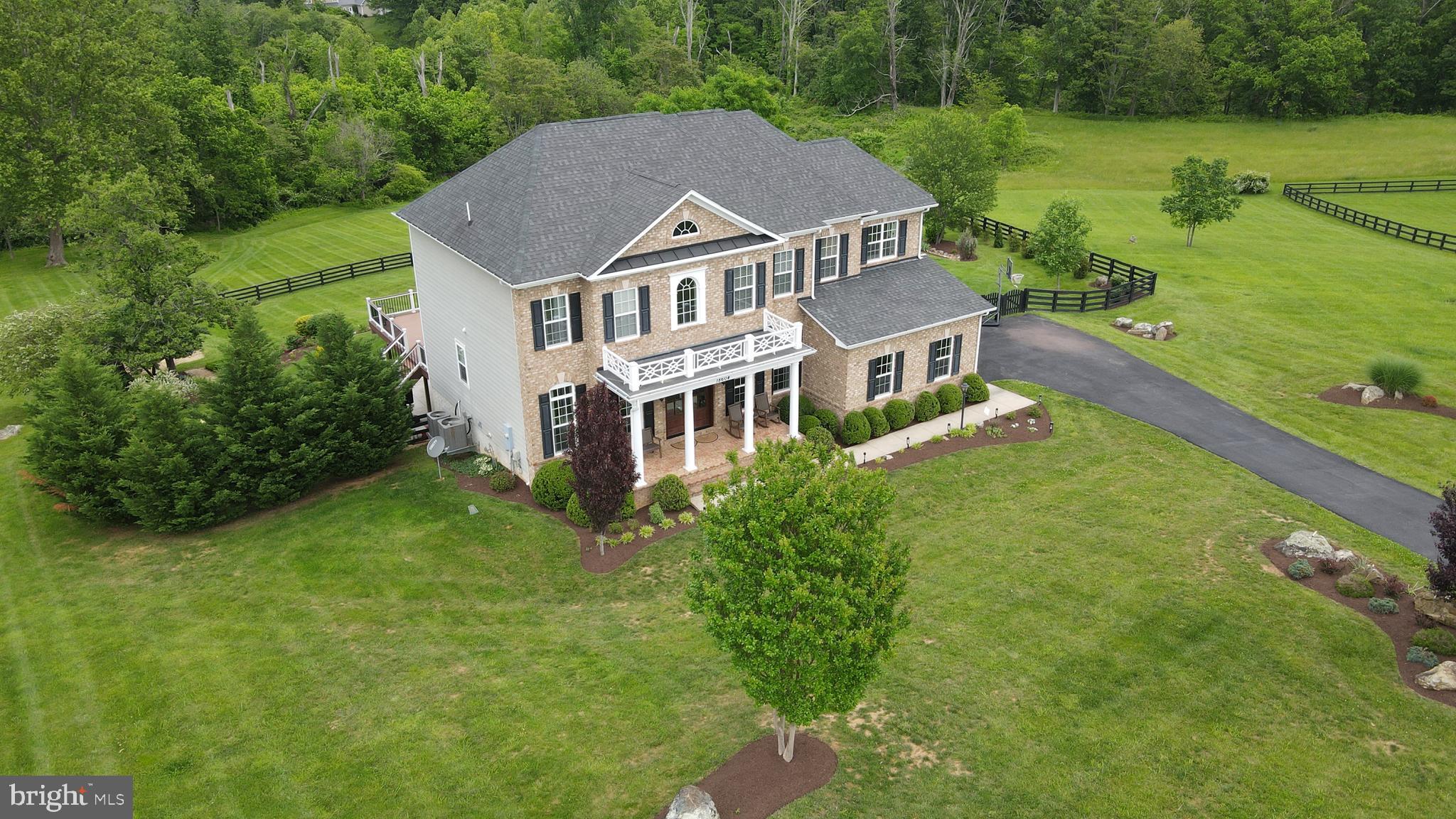 18604 Wild Raspberry Drive Purcellville, VA 20132 - Photo 50 of 58 an aerial view of residential houses with outdoor space and trees
