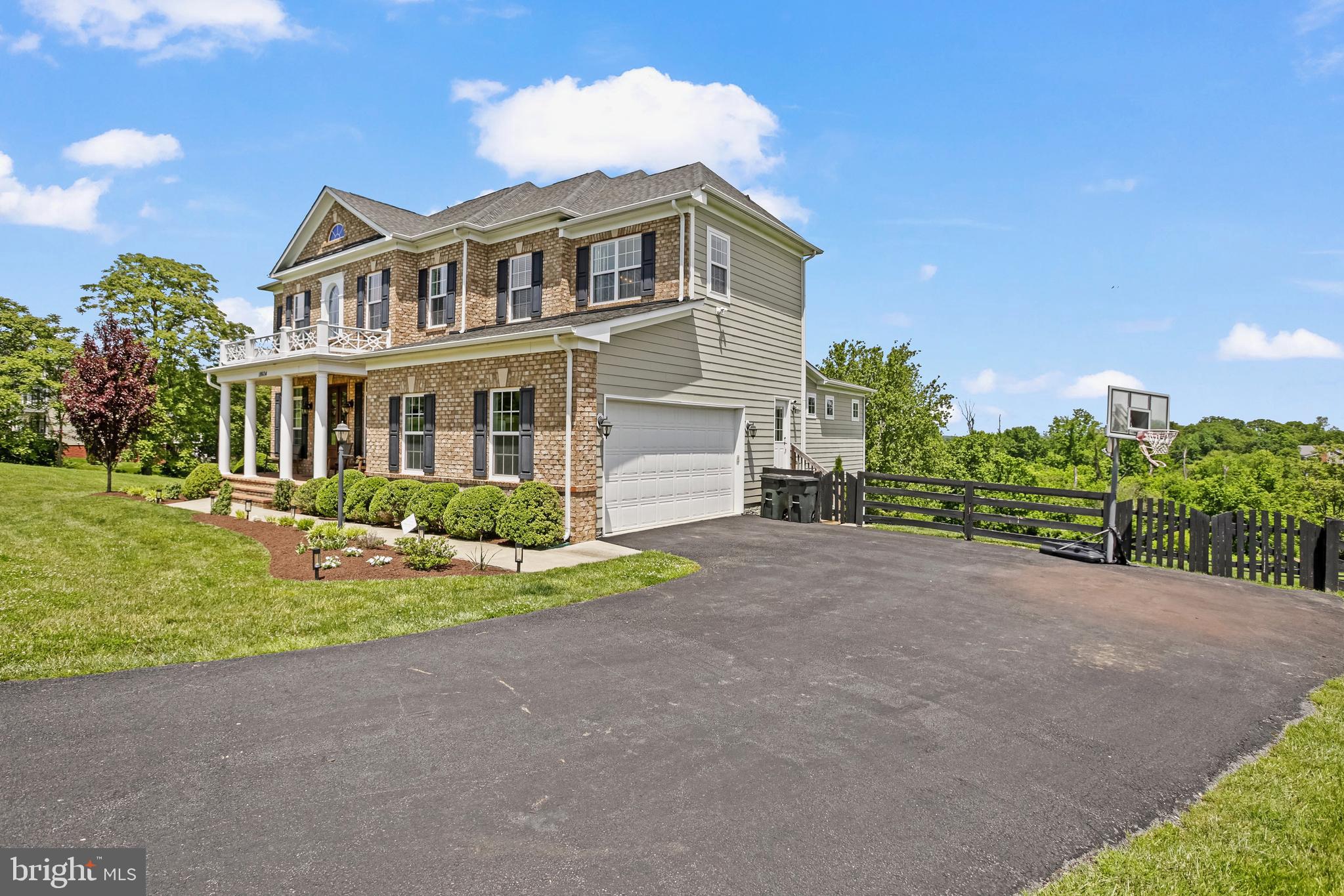18604 Wild Raspberry Drive Purcellville, VA 20132 - Photo 57 of 58 a front view of a house with a yard and garage