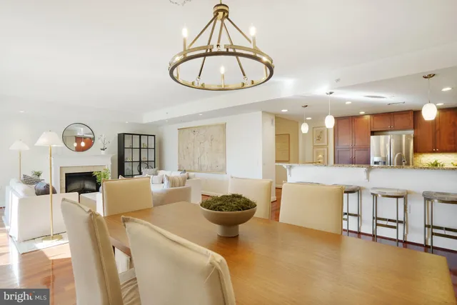 a kitchen with stainless steel appliances a refrigerator and wooden floor