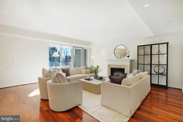 a living room with fireplace furniture and a wooden floor