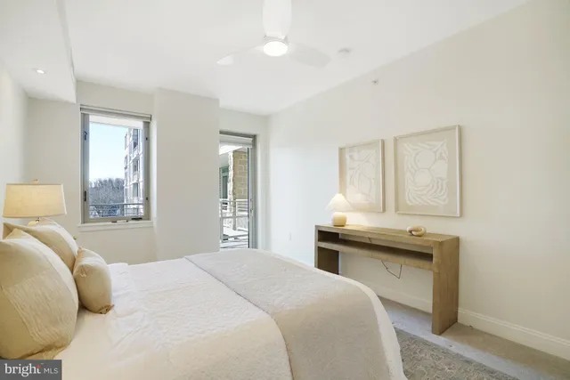 a bedroom with a bed and a lamp with the dresser