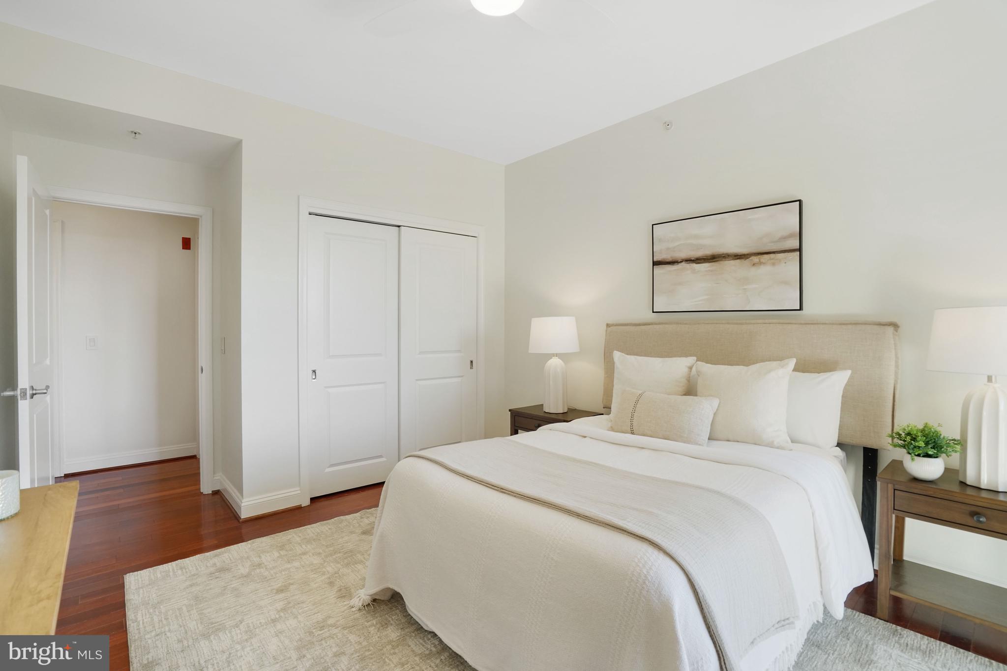 513 West Broad Street, Unit 510 Falls Church, VA 22046 - Photo 27 of 55 a bedroom with a bed and wooden floor