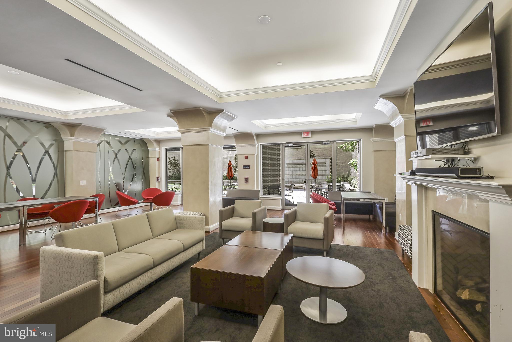 513 West Broad Street, Unit 510 Falls Church, VA 22046 - Photo 39 of 55 a living room with furniture a fireplace and a flat screen tv